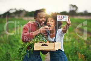 Yum yum. an affectionate young couple taking selfies while working on their farm.