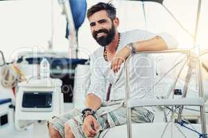 Enjoying every aspect of his surroundings. a handsome mature man on his yacht.