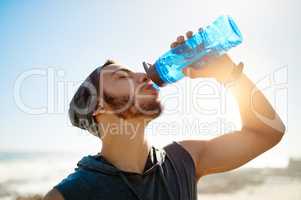 Your body cant perform at its best if youre not hydrated. a sporty young man drinking water while exercising outdoors.