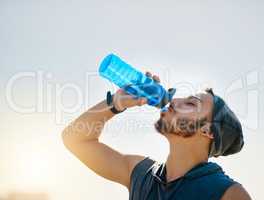 It fuels a better workout. a sporty young man drinking water while exercising outdoors.