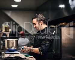 Dinner will be served shortly. a focused chef preparing a dish in the kitchen of a restaurant.