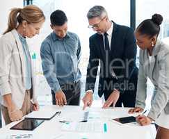 Finance, data and business people working on a graph in a modern office. Documents, teamwork and a multiracial group discuss project strategy with ceo or leader in a meeting in the boardroom.