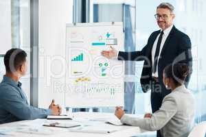 Planning, strategy and a whiteboard presentation by a businessman coaching on financial growth in a meeting. Happy team leader presenting new marketing ideas to staff in training in a conference room