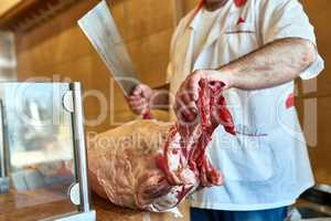 This will be chopped to perfection. a butcher at his store.