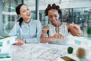 Industrial engineer or architect planning building model design project in an architecture firm. Creative woman designer working on a 3d illustration and blueprint on paper on a desk with teamwork