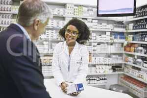 I found what you need. a cheerful young female pharmacist giving a customer prescription meds over the counter in a pharmacy.