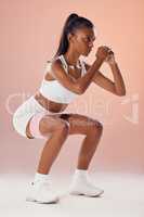 Squat, exercise and fit female athlete in a training workout for glutes, buttocks and muscle in a studio. Woman in fitness exercises, squatting for a strong core for a healthy lifestyle.