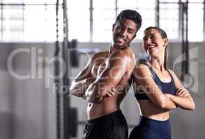 Team, gym and fitness couple doing exercise workout and living a healthy, wellness and athletic lifestyle together. Happy, energy and strong friends using teamwork for fun motivation in training