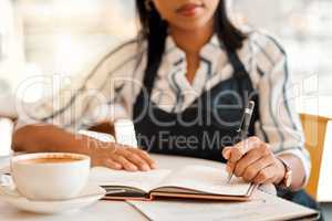 Writing, coffee shop owner and cafe entrepreneur with vision ideas, planning innovation and preparing schedule or menu. Closeup hands of restaurant barista using notebook or book to calculate finance