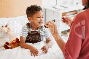 Sick child taking medicine, syrup and treatment for recovery of cold illness, flu sickness and virus symptoms. Mom caring for health of young son, kid and boy to rest in bed for wellness at home