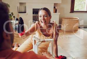 Flirting playful girlfriend teases boyfriend, moving to apartment, remodel construction furniture and diy interior design building. Laughing and happy couple love having fun redecorate lounge.