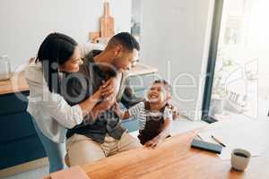 Family fun with playful, funny and happy child with a laughing parents hugging at home. Cheerful mother, father and small child with a smile relax, enjoy and spend time together at their house
