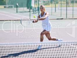 Active, fit and sporty athletic tennis player playing a friendly match at a tennis court. Female athlete learning to balance in a practice game. Lady enjoying fitness hobby she is passionate about.