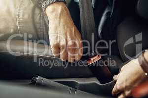 Safety comes first. Closeup shot of an unrecognizable man fastening his seatbelt in a car.