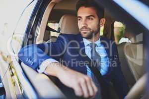 This traffic is always crazy. a confident young businessman contemplating while being seated in his car.