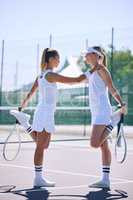 Athletic tennis players stretching before playing a game, sporty friends bonding at a tennis court. Fit, professional athletes bonding while warming up, enjoying their friendship before competing