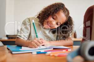 Learning, smiling and creative young girl drawing with a colorful pencil feeling happy and content. Positive student with a smile having a fun time creating artistic art in her kids notebook at home