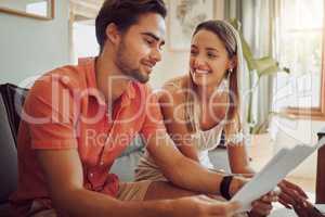 Bank loan approved, mortgage or home deposit is successful for a happy couple reading paperwork at home. Lovers planning financial budget and expenses or tax and are happy about salary