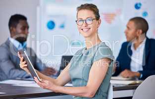 Boardroom executive, leader and manager browsing on tablet during meeting in an office. Portrait of a smiling, proud and caucasian entrepreneur, motivated business woman and ceo in a corporate agency