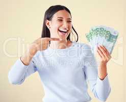 . Money, investment growth and finance success of a happy, excited and smiling woman pointing at cash reward. Lucky and happy female showing her growing financial wealth, savings or bank loan payout.