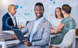 Portrait of a confident business man leading a meeting in a modern office, smiling and empowered. Happy black male discussing innovative strategies, marketing, planning and creative startup strategy