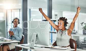 Call centre, cheerful and agent celebrating with arms up at her office desk. Successful, professional and positive customer review or bonus. Helpdesk worker excited with salary performance increase.