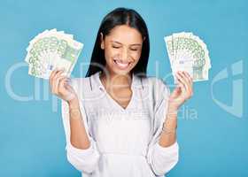 Money, winner and cash in hands of a woman cheering wealth and success in celebration with a wow in studio on blue background. Rich, celebrating and excitement with a happy female winning the lottery
