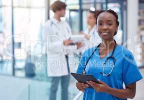Nurse, professional and healthcare worker with tablet in medical center, clinic and hospital while analyzing test result. Portrait of frontline worker showing trust, care and knowledge about medicine