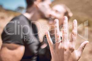 Engagement, proposal and romance while showing off her diamond ring and saying yes to marriage outside. Closeup hand of a young romantic couple telling you to save the date for their wedding day