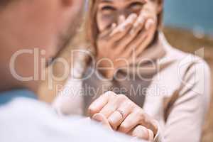 Engagement, proposal and romance wth a man asking his fiance to marry him while dating and spending time together. Closeup of a ring on the finger of a woman who just say yes to a marriage proposing