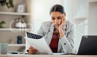 Bored, thinking professional businesswoman reading and managing company financial crisis strategy report. Stressed employee working on investment loss of economy market shares of company