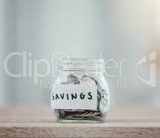 Savings, money and finance with many silver coins in a jar for retirement, banking and investment growth. Start to save for college, pension or wealth with financial freedom from saved income