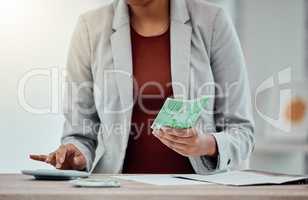 Banking, accounting and finance with an insurance broker or moneychanger typing on a calculator, comparing currency and exchange rates. Closeup of a business woman holding cash, money or bank notes