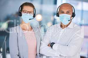 Customer service workers, with protection from covid and wearing masks for heath. Online support, IT or call center employees with headset, social distancing during corona virus pandemic or lockdown