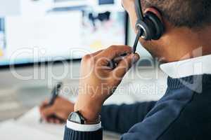 Call center, customer service and agent assisting online customer with a headset and taking notes. Closeup of a male financial consultant or telemarketer working on a computer to consult clients.