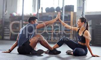 Motivation, celebrate and support with fitness coach doing high five with woman in the gym. Active and fit woman training or practicing strength and stamina workout with her friend in a health center