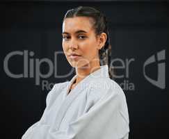 . Karate, judo or taekwondo woman in white kimono for martial arts, jiu jitsu and kung fu against a black studio background. Portrait of a determined, serious and focused fighter ready for combat.