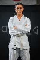 . Karate pro, women empowerment and training mindset of a serious, learning sport student. Portrait of a fight and fitness athlete with focus in a sports studio, dojo school or martial arts gym.