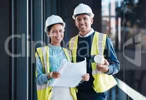 Construction, engineering and building with a contractor, maintenance worker and technician working together as a team on a development site. Engineer and builder looking at plans or blueprints