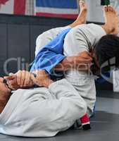 Fight, karate and martial arts teamwork in competition, challenge or combat sport in wellness studio. Sports trainer or fitness coach teaching student in gym workout, exercise and training for health