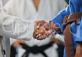 . Handshake, respect and discipline with mma, karate and fight students shaking hands before a match or combat sport in a training gym or dojo. Training, exercise and workout in self defense class.