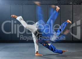 Fitness, strength and men in a karate fight in a gym for martial arts exercise. Action, motion and learning to take down the competition, training to overcome, fight failure and the motivation to win