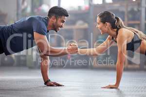 Support, teamwork and fitness couple doing workout training, challenging exercise for endurance, strength and stamina in a gym. Active, fit man and woman giving support and motivation during pushup