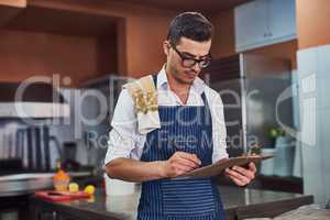 Time for the inventory checklist. a man working at a restaurant.