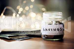Savings jar, money notes and change of saving for bank investment, retirement and financial safety. Closeup of financial growth after a banking finance budget and spending less to save for the future