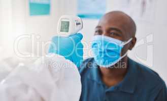 Checking for covid, corona or fever with a patient wearing a mask for hygiene, sickness or flu symptoms in a health clinic. Medical doctor holding a thermometer to scan the temperature of a patient