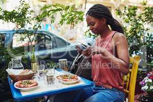 I just have to upload a picture of this food. a woman taking a picture of her food.