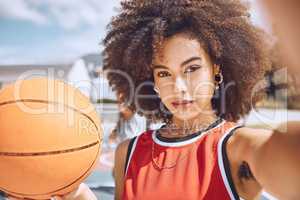 Cool selfie of basketball player with funky, confident and hipster attitude ready for game, fun or playing outdoor sport match. Portrait of young, beautiful and black woman with afro hair on court