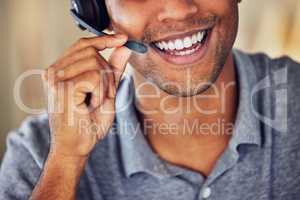 . Happy, smiling and friendly call center agent wearing headset while working in an office. Closeup smile of a confident man consulting and operating helpdesk for customer sales and service support.