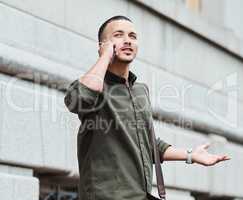 Lost man, traveler or tourist talking on a phone call asking for directions in a new city. A confused young male on vacation in an urban town looking around to find his hotel or the airport